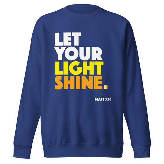 A royal blue crew neck sweatshirt featuring the text 'LET YOUR LIGHT SHINE' in bold white, yellow, and orange lettering on the front, with 'MATT 5:16' printed in white below.