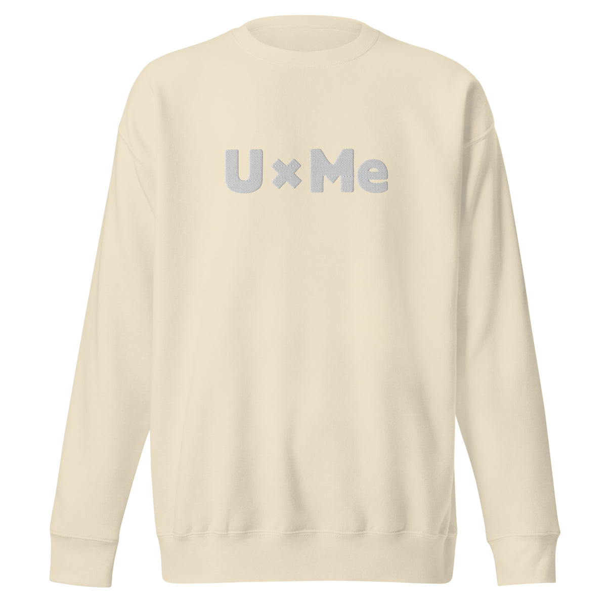 A bone coloured crew neck sweatshirt with the text 'UxMe' embroidered in bold white letters across the chest